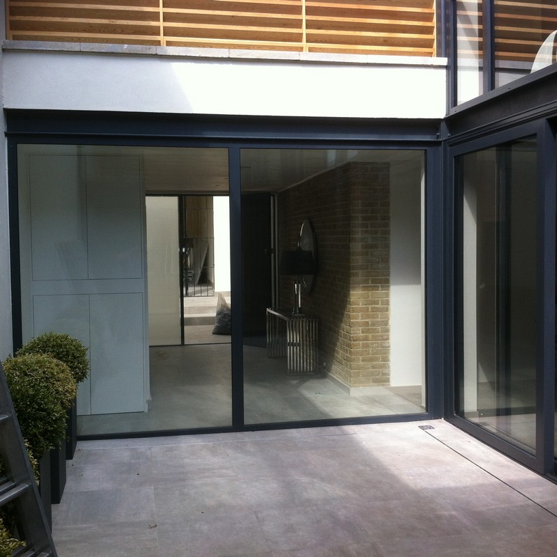 Floor-to-ceiling sliding doors opening to courtyard in Edgware